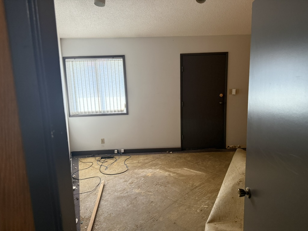 The first private treatment room with a window and exterior door during renovation