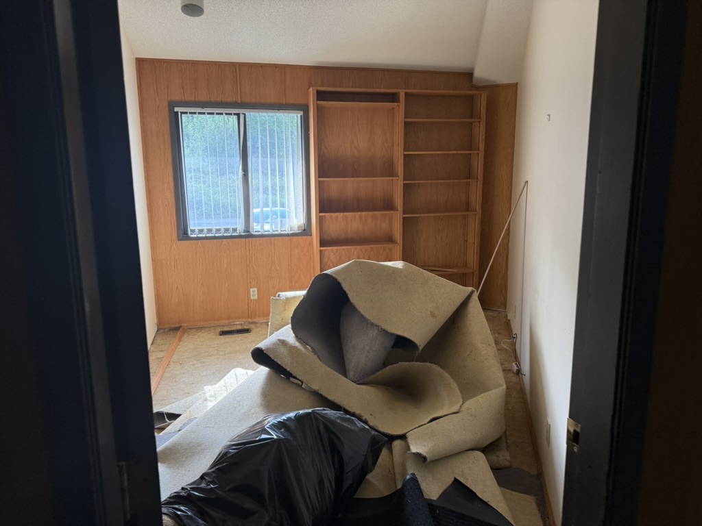 The second private treatment room with a window and built-in shelving during renovation